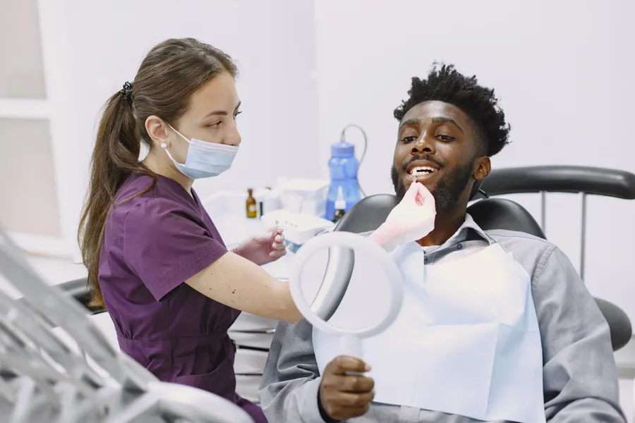 Dentist and patient reviewing cosmetic dental bonding options in China - QGO Medical