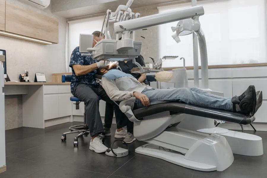 Dentist treating patient in a modern clinic for cosmetic and general dentistry comparison in China - QGO Medical
