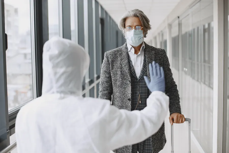 International traveler with suitcase during medical travel planning for dental care in China - QGO Medical