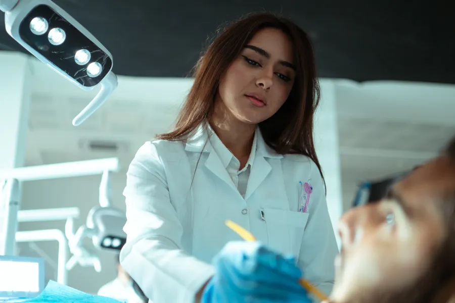 Dentist performing dental bonding planning in a modern clinic in China - QGO Medical
