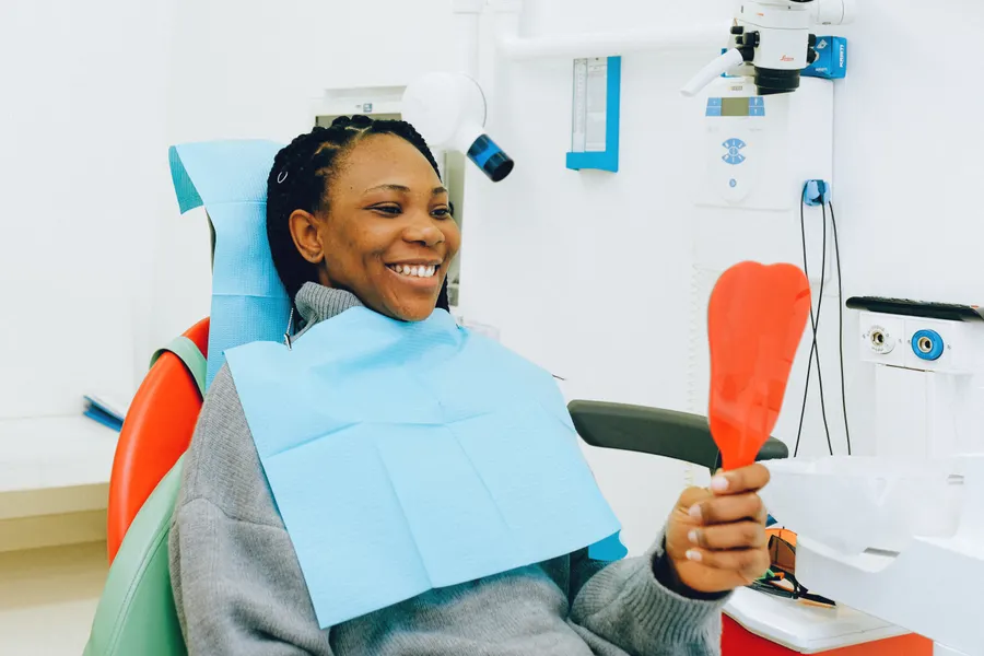 Patient checking smile after dental bonding planning in China - QGO Medical